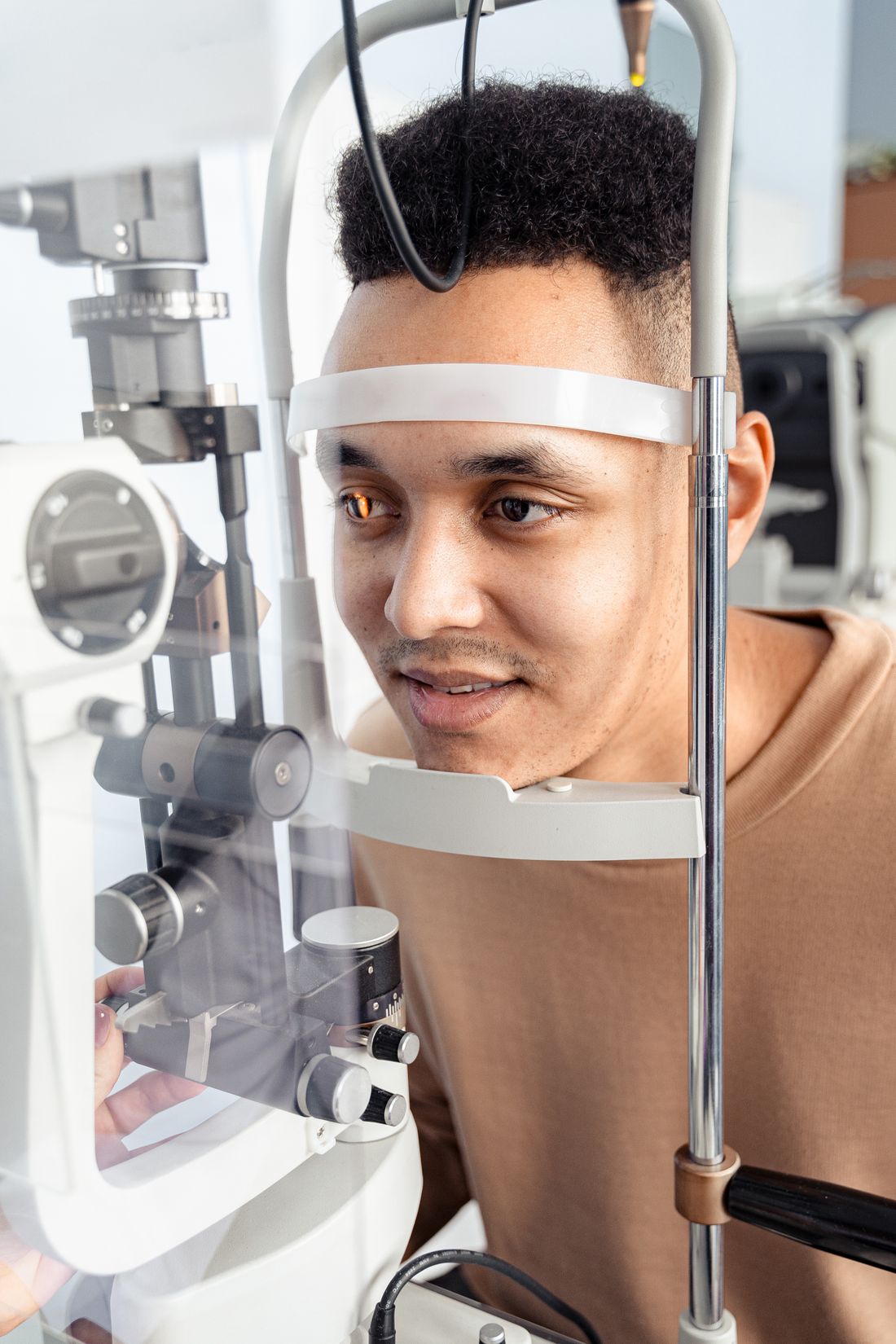 Optometrist examining a patient's eyes with a slit lamp